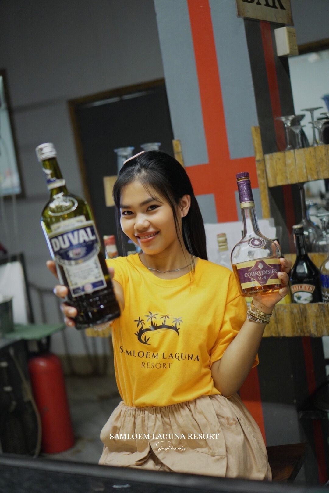 Staff member smiling in the restaurant bar area